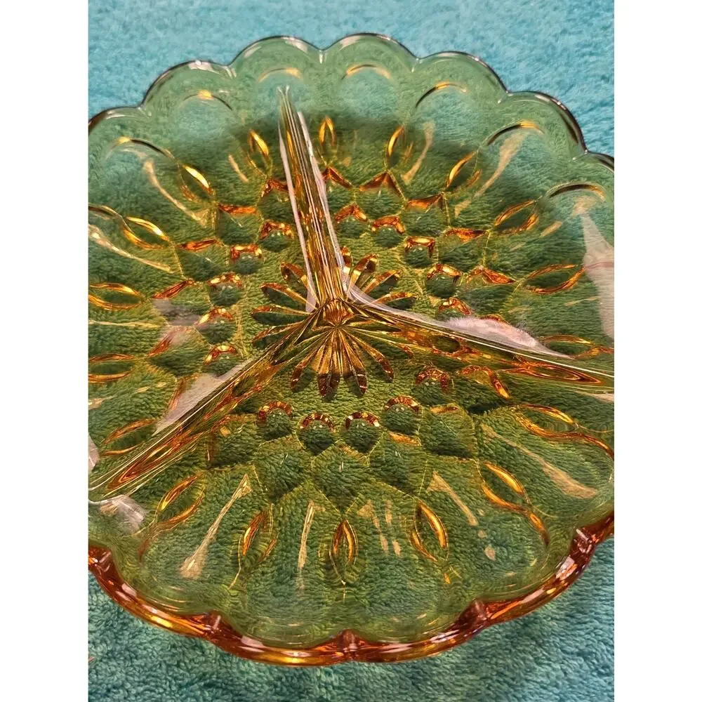 Vintage amber glass divided relish dish with pressed floral pattern.